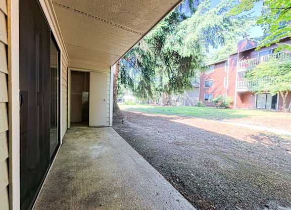 A view from a doorway looking out onto a driveway.