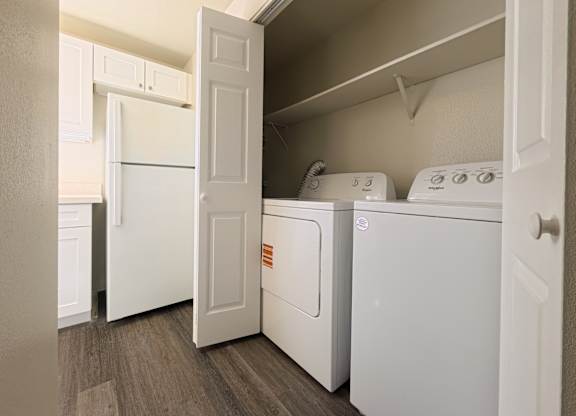 A white washing machine and dryer in a laundry room.