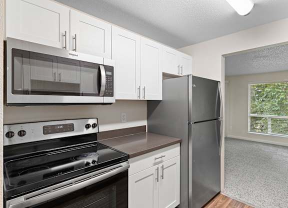 Beautiful kitchen, white cabinets and stainless steel appliances.