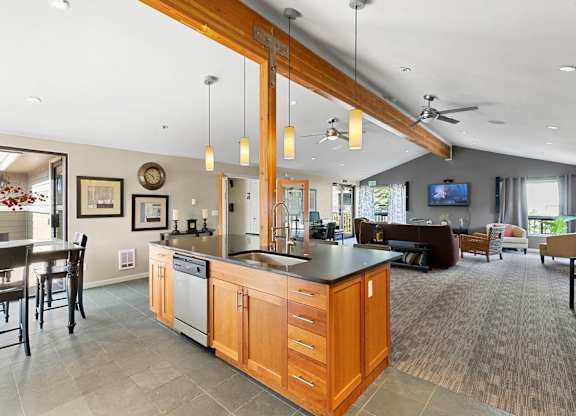 A modern kitchen with wooden cabinets and a large island.