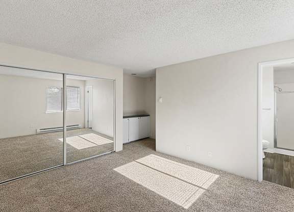 A room with a carpeted floor and a glass door.