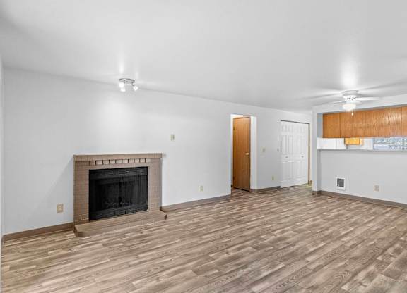 A room with a fireplace and wooden flooring.