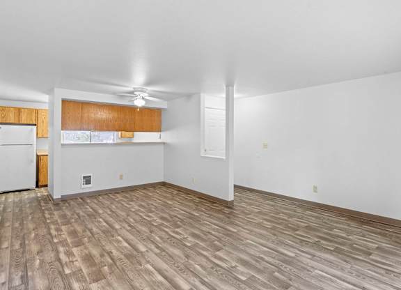 A room with wooden flooring and white walls.