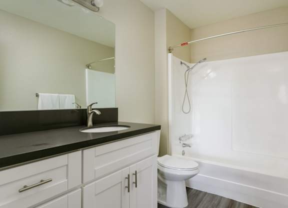 A white toilet sits next to a sink in a bathroom.