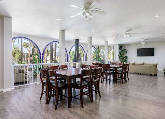 A dining room with a large table and chairs.