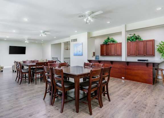 A dining room with a long table and chairs.