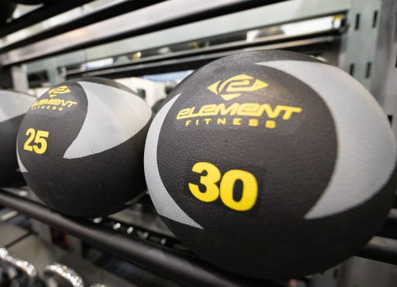 a close up of three dumbbells on a rack at Wynnwood Vinings Atlanta fitness center