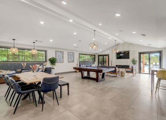 the entertaining room has a large table with chairs and a tv