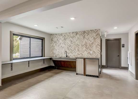 A bathroom with a large tub and a window.