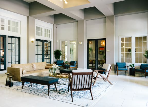 Tapestry at Hollingsworth Park club house with a couch and chairs and a rug