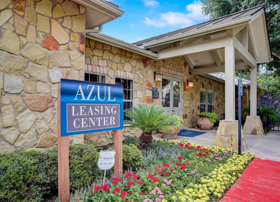 azu leasing center sign in front of a stone building