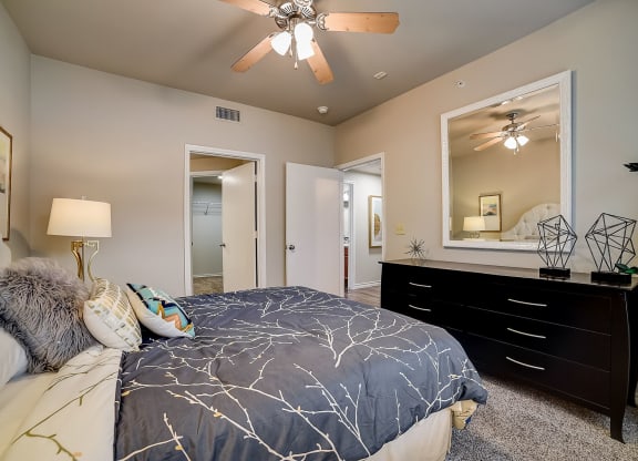 a bedroom with a large bed and a large mirror