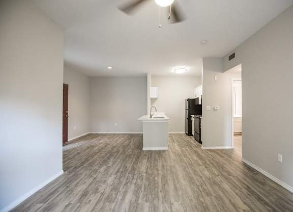 A room with a wooden floor and a white counter.
