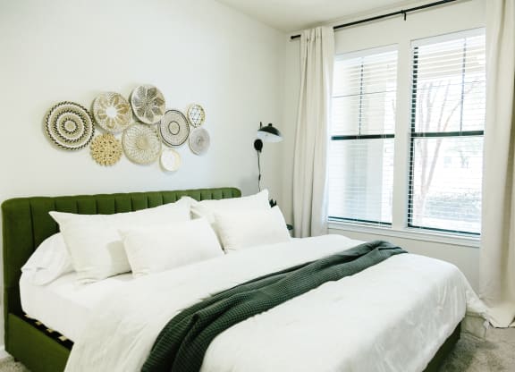 Tapestry at Hollingsworth Park bedroom with a large white bed with white sheets and pillows