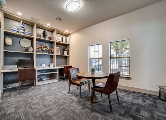 a room with a table and chairs and a bookshelf