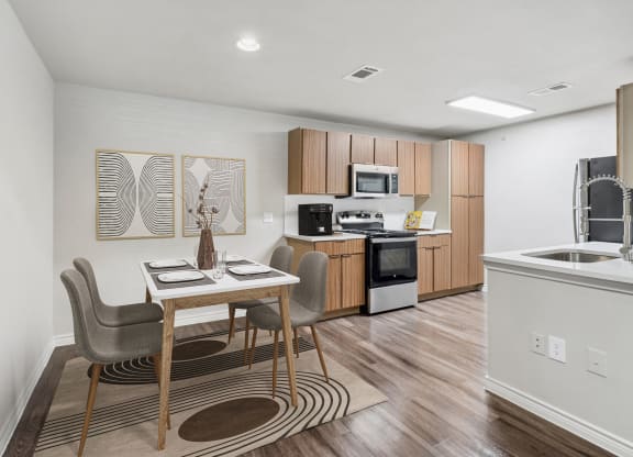 a kitchen and dining room with a table and chairs
