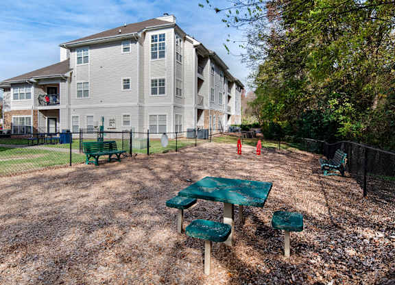 A large apartment complex with a playground in front.