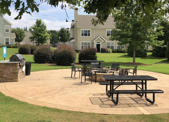 a patio with tables and chairs at Millennium Apartments Greenville SC