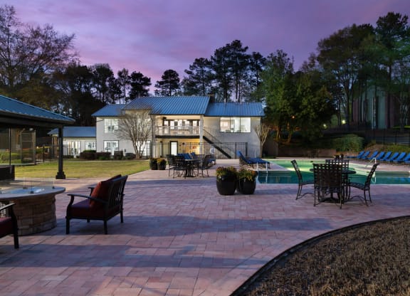 a backyard with a paver patio and a swimming pool