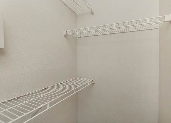 Empty white shelves in a room.