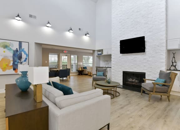 Canopy at Baybrook renovated Leasing Office with a modern couch fireplace and TV