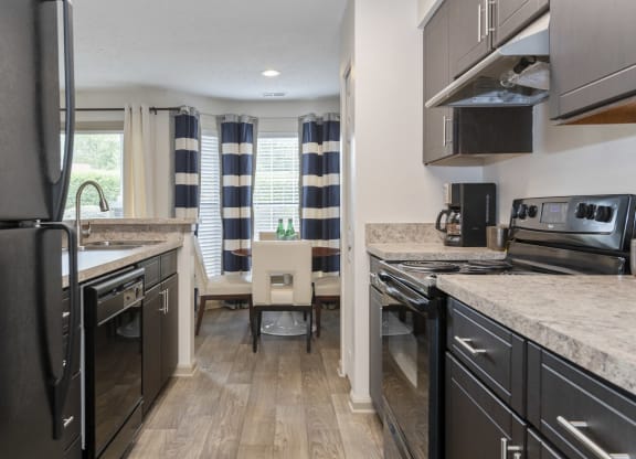 a kitchen and dining area at Canopy at Baybrook apartments in South Charlotte