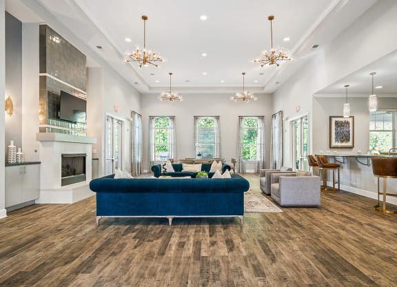 a living room with a blue couch and a fireplace