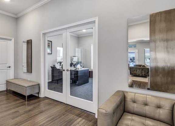 a club room with a couch and a door to a office