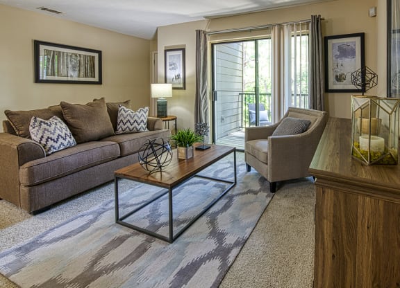 a living room with a couch chair and coffee table at Wynnwood Vinings