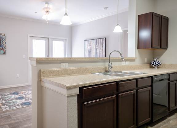 A kitchen with brown cabinets and a white countertop.
