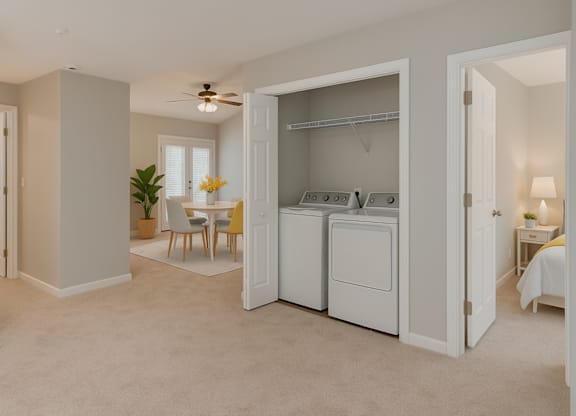 A white laundry room with a washer and dryer.