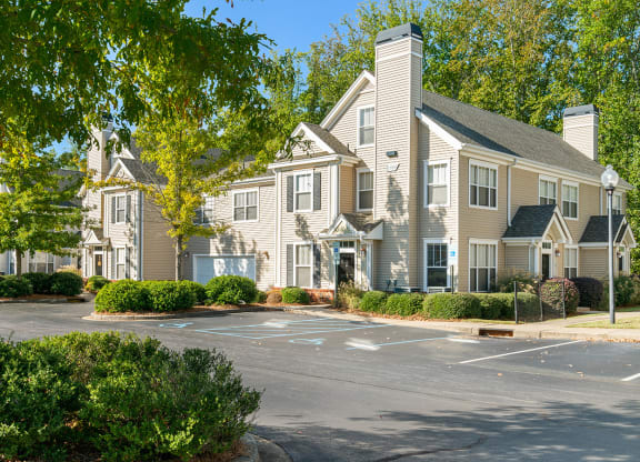 a parking lot in front of a row of apartment buildings