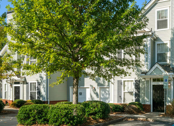 a large white house with a tree in front of it