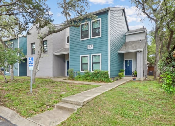 a blue house with a blue door and gray and white siding