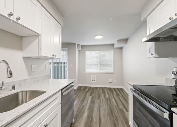 a kitchen with a sink and a stove and a window