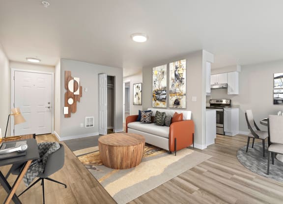 a living room with hardwood floors and view into dining room and kitchen at Foster Creek apartments in Tukwila