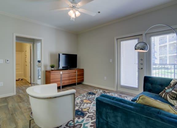 heights at converse apartments living room with rug chairs and TV