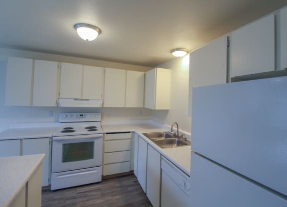 Apartments for Rent in Tacoma, WA - Valley Vista - Kitchen with Wood-Style Flooring, White Countertops, White Cabinets, and White Appliances