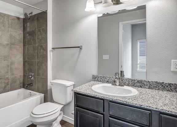 a bathroom with a sink toilet and a tub