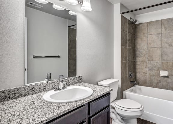 the preserve at ballantyne commons bathroom with tub sink toilet and mirror