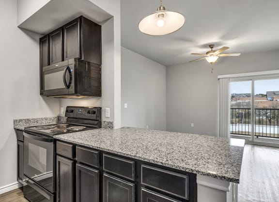 the kitchen of a home with a granite counter top