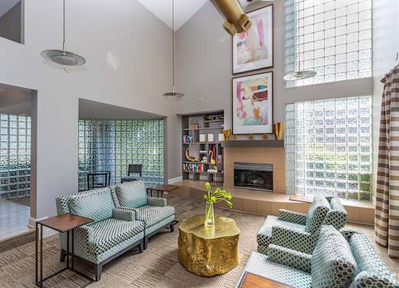 A living room with a fireplace and a large window.