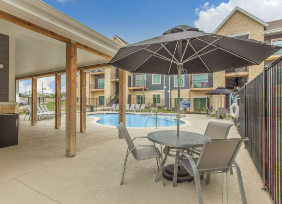 Poolside Pavilion and BBQ grill area at  Sendero Ridge Apartments Kerrville