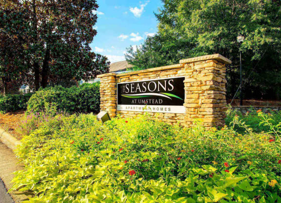 Entrance sign to Seasons at Umstead at the entrance of an apartment community