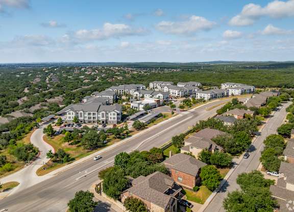 A bird's eye view of a residential area with houses and a road.
