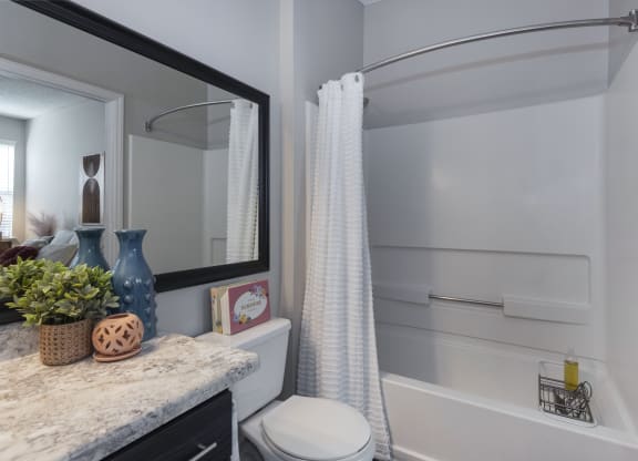 a bathroom with gray walls and a white shower curtain