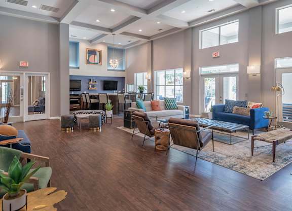 A spacious living room with a variety of seating options and a fireplace.