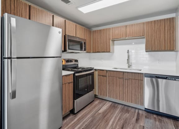 a kitchen with stainless steel appliances and wooden cabinets