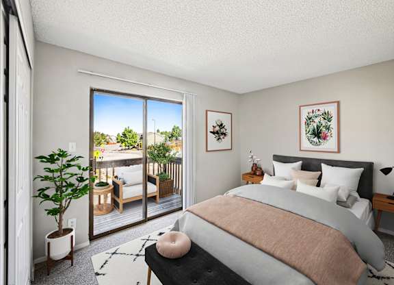 A bedroom with a large bed and a view of a balcony with furniture.