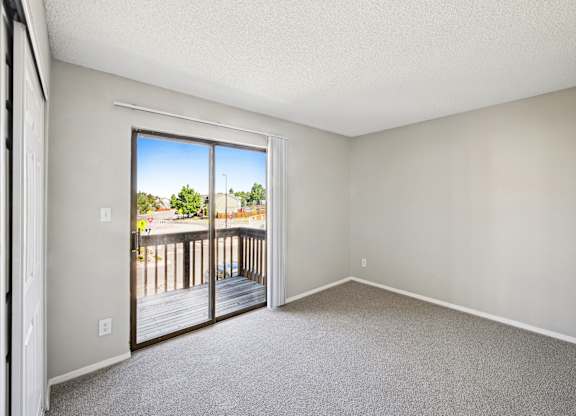 an empty bedroom with white walls and carpet